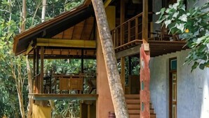 A wooden structure with a balcony and stairs, surrounded by trees. - Sama Retreats (Galle)