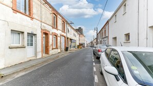 A narrow street lined with buildings, parked cars, and a clear sky. - Le fil de l'Evre - Au coeur des Mauges (Le May-sur-Èvre)