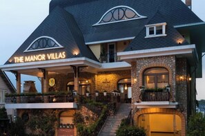 A multi-story building with a stone facade and a sign reading 'The Manor Villas.' - The Manor Villas - Dong Da (Dalat)
