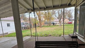 A porch with a wooden swing. - Welcome to your getaway destination in Craig's rugged outdoors loving terrain. (Craig)