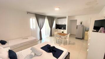 Deluxe Studio, Pool View, Poolside | Living area | 32-inch LCD TV with cable channels