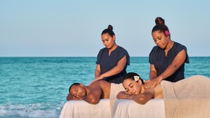 A massage therapy session on a beach with a clear view of the ocean. - GO TO THE BEACH STAYS (Punta Cana)