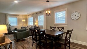 A dining area with a wooden table and chairs, a sofa, and a lamp. - Peaceful Home near Historic Strasburg (Lancaster)