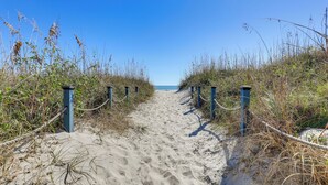 A sandy beach path with blue posts and ropes, leading to the sea. - Steps to Sea! 3rd-Floor Myrtle Beach Condo w/ Pool (Myrtle Beach)