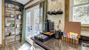 A kitchen with wooden shelves, a coffee maker, and a snack drawer. - Raft, Hike & Fish: Quiet Couple's Escape in Murphy (Murphy)