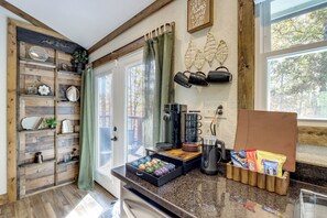 A kitchen with wooden shelves, a coffee maker, and a snack drawer. - Raft, Hike & Fish: Quiet Couple's Escape in Murphy (Murphy)