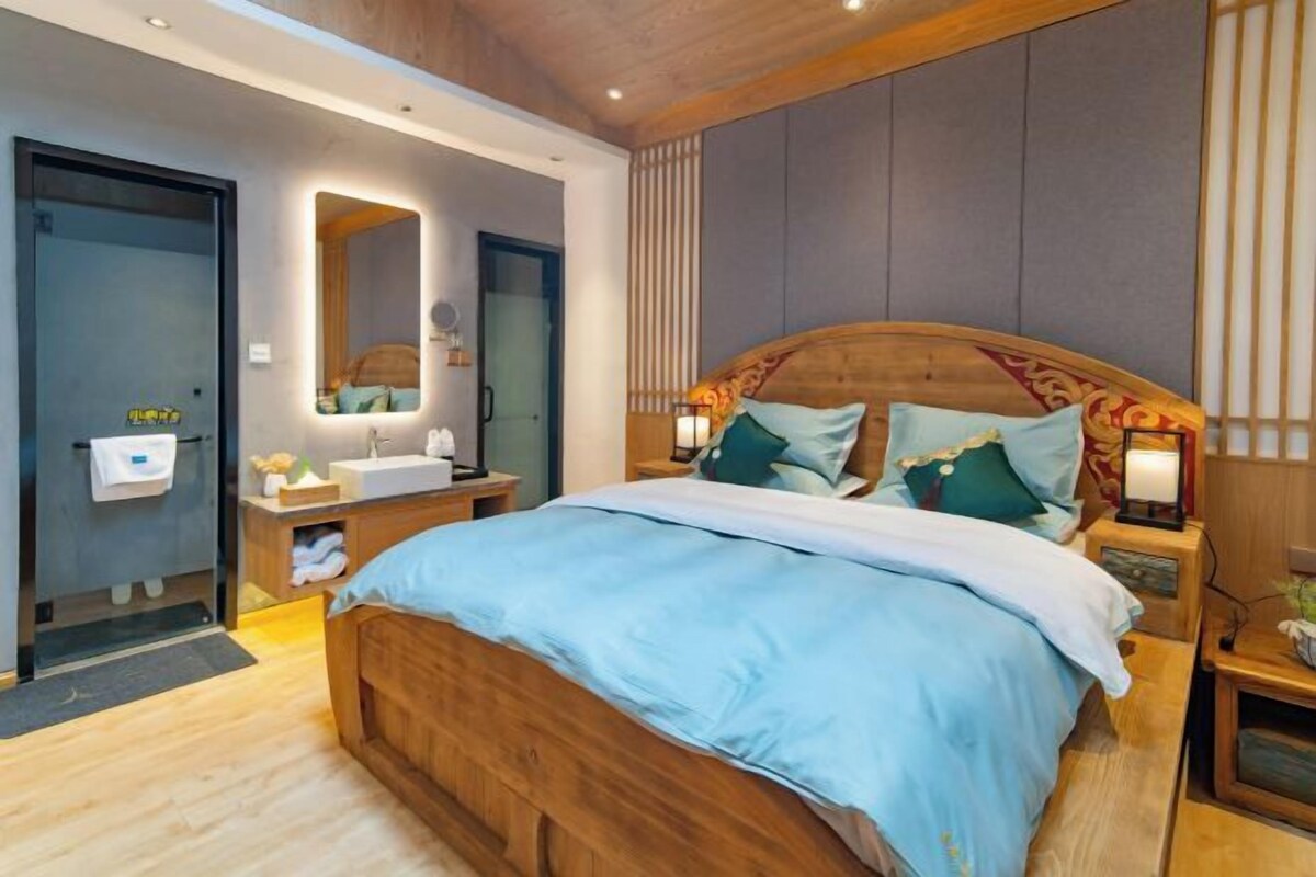 A modern bedroom with a wooden bed, bedside tables, a mirror, and a nightstand.