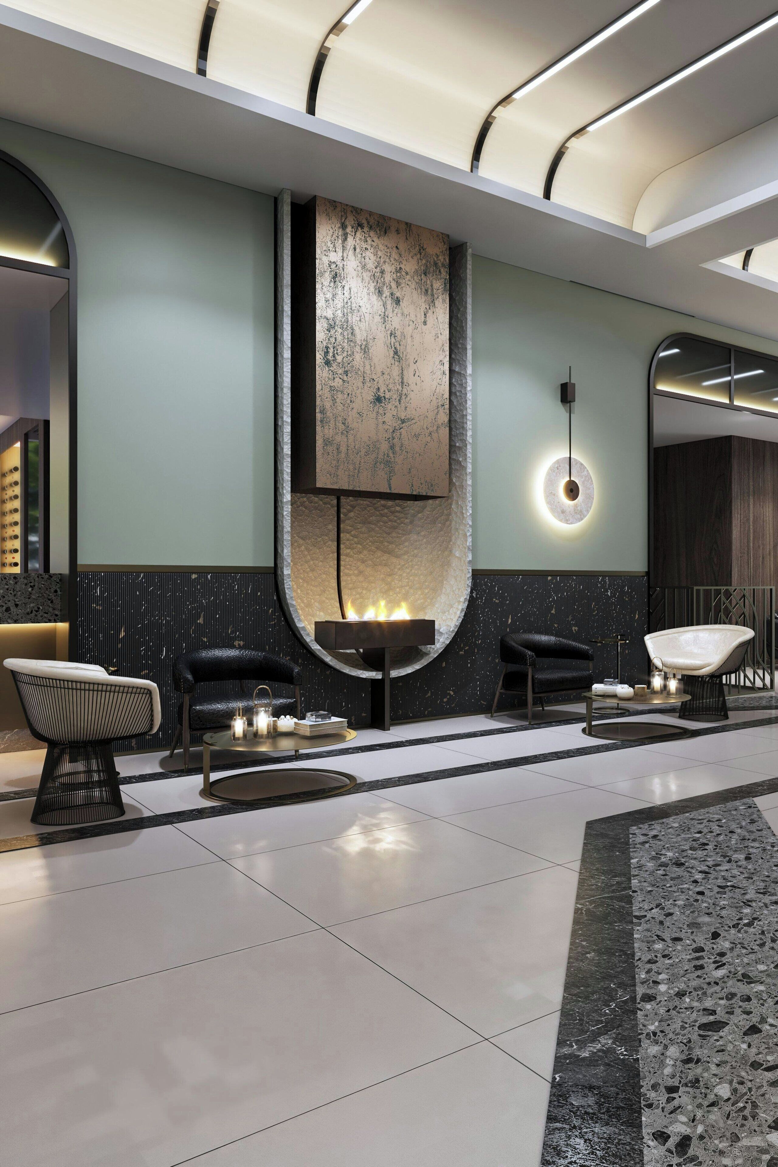A modern lobby with a central fireplace, seating area, and a large mirror.