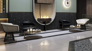 A modern lobby with a central fireplace, seating area, and a large mirror. - Le Méridien Toronto Pinnacle Hotel (Toronto)