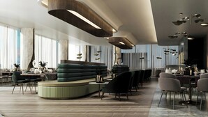A modern interior with a curved seating area, a dining setup, and contemporary lighting fixtures. - Le Méridien Toronto Pinnacle Hotel (Toronto)