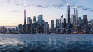 A city skyline with high-rise buildings, a prominent tower, and a body of water in the foreground. - Le Méridien Toronto Pinnacle Hotel (Toronto)