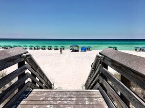 A wooden staircase leading to a beach with green umbrellas and beach chairs. - Lux/Golf Cart/Pool/Close2Beach (Santa Rosa Beach)