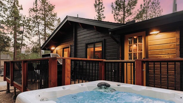 A wooden cabin with a hot tub in front, surrounded by trees. - Shadow Wood Lodge, w Hot Tub near Ski Slopes (Big Bear Lake)