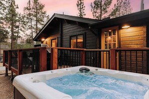 A wooden cabin with a hot tub in front, surrounded by trees. - Shadow Wood Lodge, w Hot Tub near Ski Slopes (Big Bear Lake)