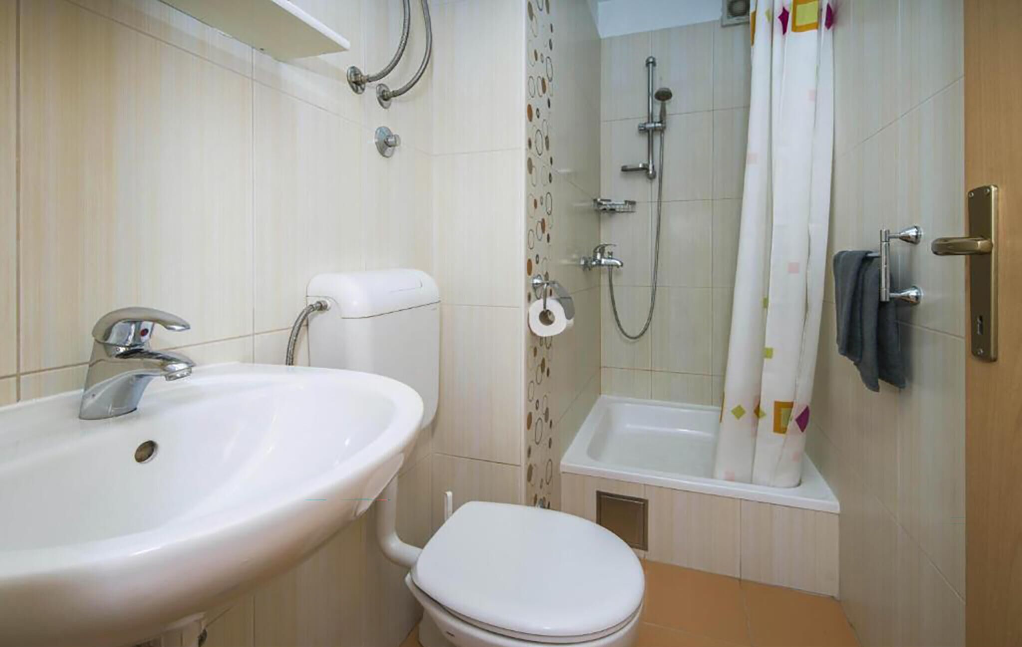A bathroom with a sink, toilet, shower, and bathtub.
