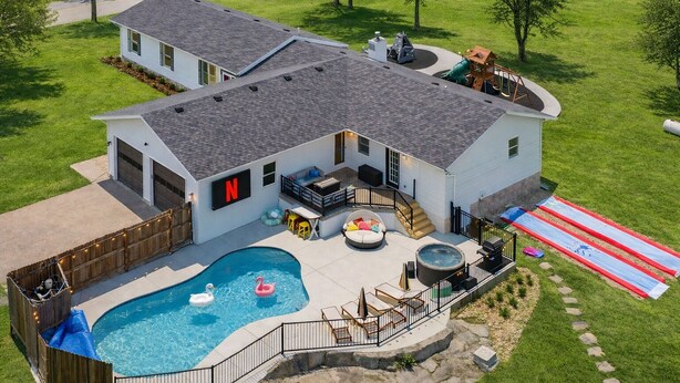 A two-story house with a backyard swimming pool, a hot tub, and a play area. - Private Pool & Pickleball Court | Pet-Friendly (Branson)