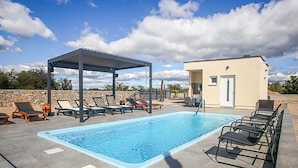 A swimming pool with lounge chairs and a covered seating area. - Gorgeous (sta)caravan in Drnis with WiFi (Drnis)