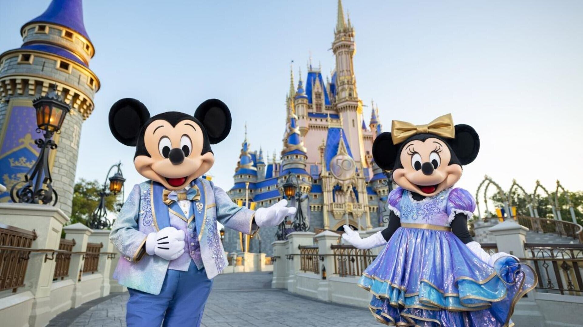Mickey and Minnie Mouse in front of a castle.