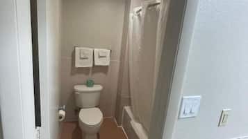 Bathtub, soap, shampoo, toilet paper