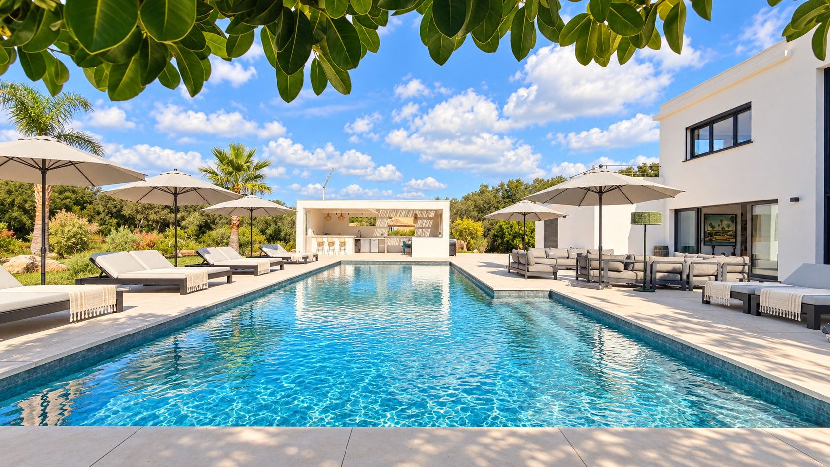 A swimming pool with lounge chairs and umbrellas, surrounded by greenery and a modern building.
