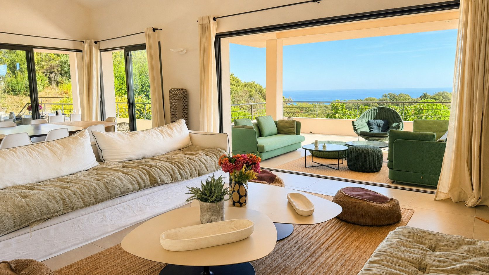 A modern living room with a sofa, green armchairs, and a coffee table.