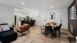 A modern apartment with a dining area, kitchen, and living room. - NEW! Ski, Sauna, Jacuzzi, Nintendo, Game Room, Fireplace (Brian Head)