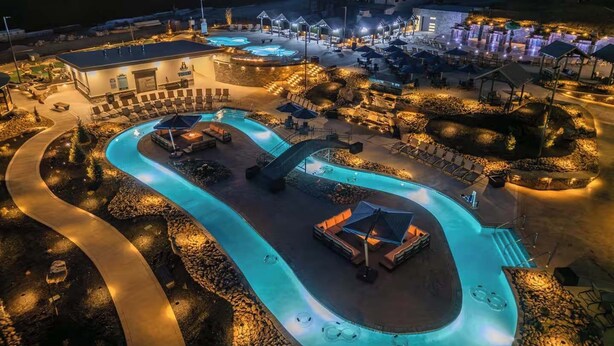 A resort with a large swimming pool, sun loungers, and a covered seating area. - Heated Pool-Mtn View-Game Loft-Waterpark-Sleeps 20 (Sevierville)
