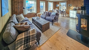 A cozy living room with a sofa set, a coffee table, and a fireplace. - Nice home in Rauland with WiFi (Rauland)