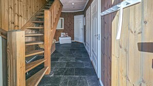 A wooden interior hallway with a staircase, a white door, and a bench. - Nice home in Rauland with WiFi (Rauland)