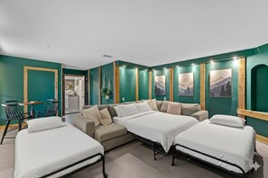 A hotel room with two beds, a sofa, a dining table with chairs, and a view of the outdoors. - 3 Kings! Hot Tub/Pool-Fire Pit-GameRm GYM+ PickleB (Canyon Lake)
