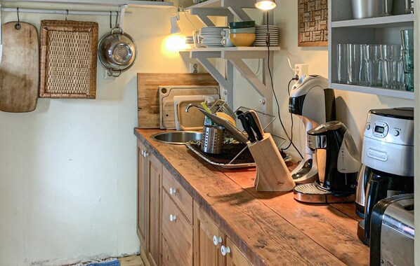 A kitchen with wooden cabinets, a coffee maker, and various kitchen utensils. - Pet friendly home in Värmdö with WiFi (Värmdö)