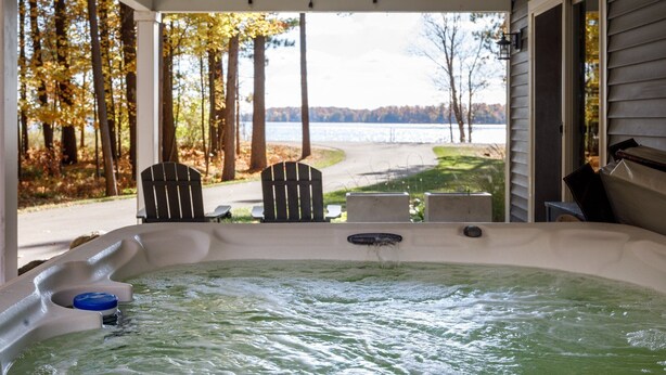 A hot tub with a view of a lake and trees. - The Long Lake Escape (Traverse City)
