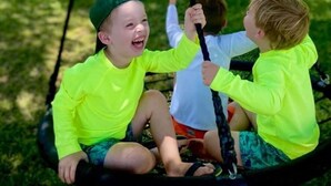 A swing set in a park with a lake in the background. - Lakeside Valentine (Kingsland)