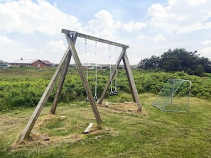 A wooden swing set in a grassy field with a soccer goal in the background. - 4 Star Holiday Home in Harboore (Harboore)