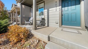 A residential building with a blue door, a covered porch, and a stone pathway leading to the entrance. - Hummingbird Haven-Prime location in South Longmont-sleeps 8,4beds,blocks to Rec (Longmont)