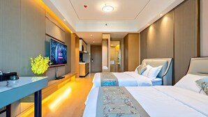 A modern hotel room with two beds, a desk, a TV, and a bathroom visible in the background. - Aifte International Apartment (Guangzhou)