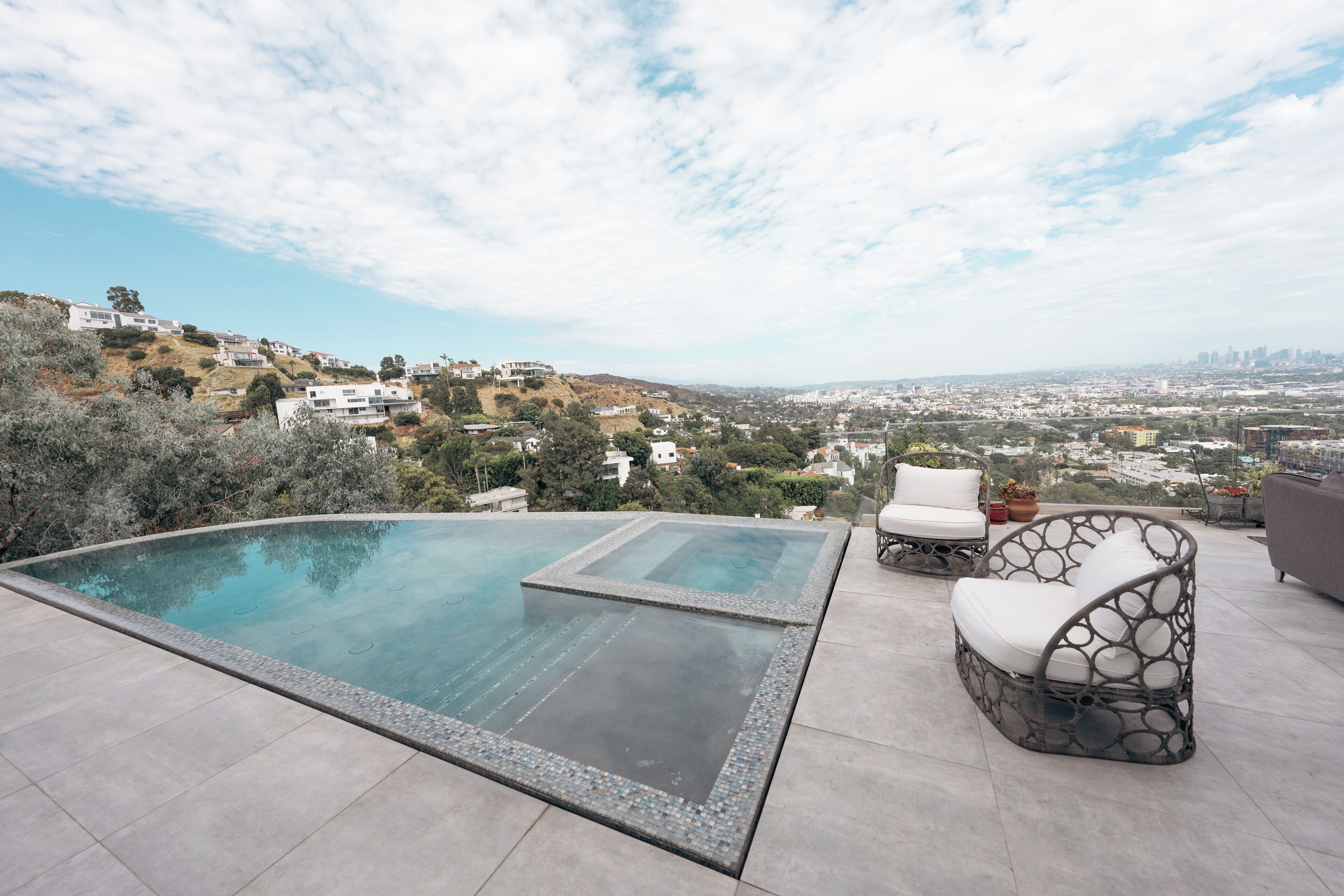 A rooftop infinity pool with a clear view of the cityscape.