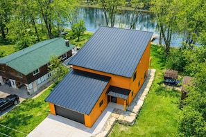 A two-story house with a sloped roof, a garage, and a small porch.