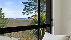 A room with a large window offering a view of a mountainous landscape. - Fern & Maple Lodge Wentworth Falls (Wentworth Falls)