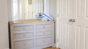 A room with a light grey dresser with four drawers and a mirror above it. - Sojourn Willoughby Spit Chic Shack <1min. to Beach (Norfolk)