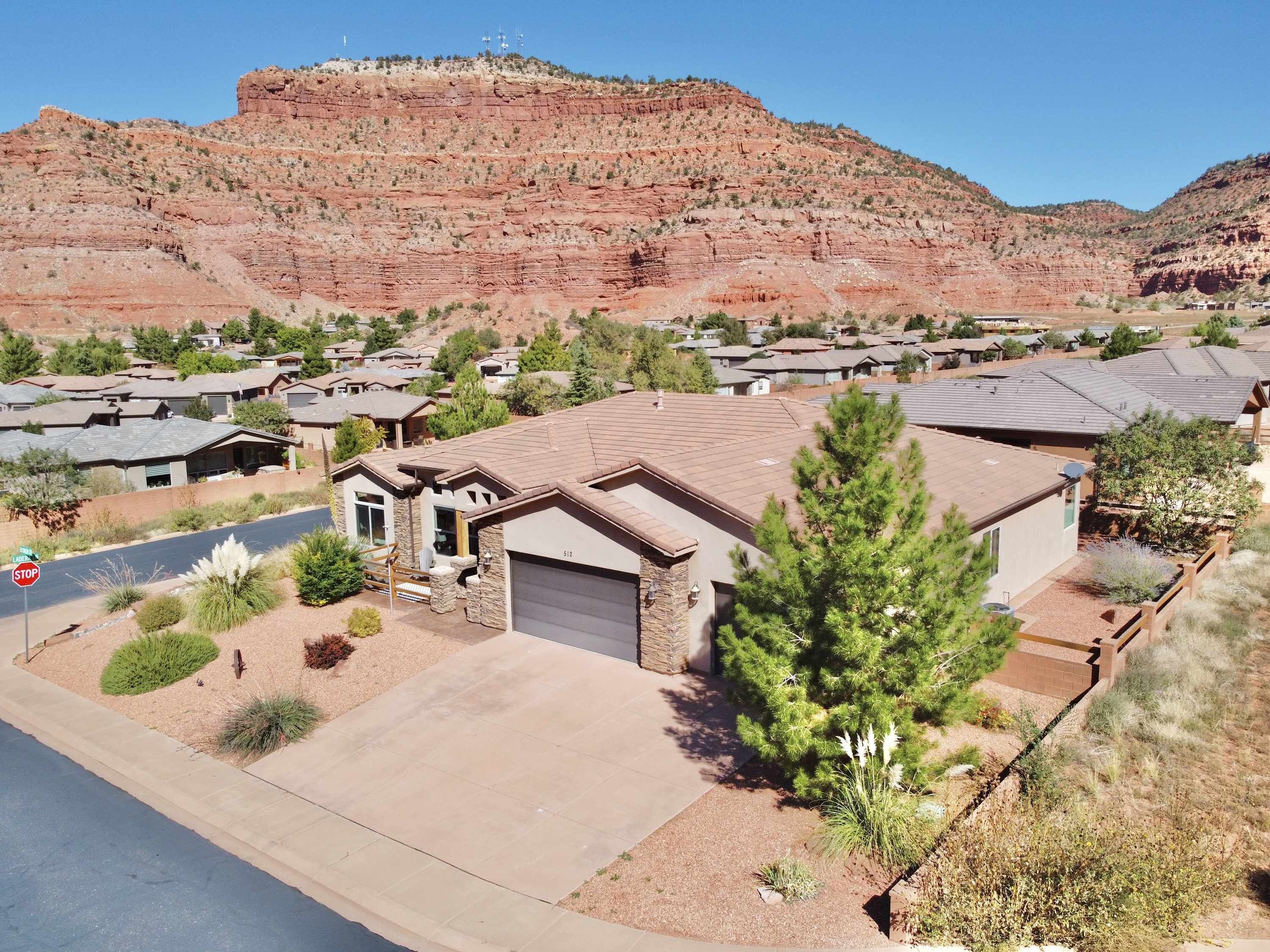 Luxury home on a corner lot in a beautiful neighborhood wrapped in stunning red rock cliffs.