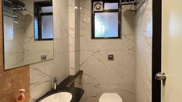 Deluxe Quadruple Room, 2 Double Beds, Balcony, City View | Bathroom | Shower, free toiletries, bidet, towels