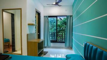 Deluxe Quadruple Room, 2 Double Beds, Balcony, City View | In-room safe, individually decorated, individually furnished, desk