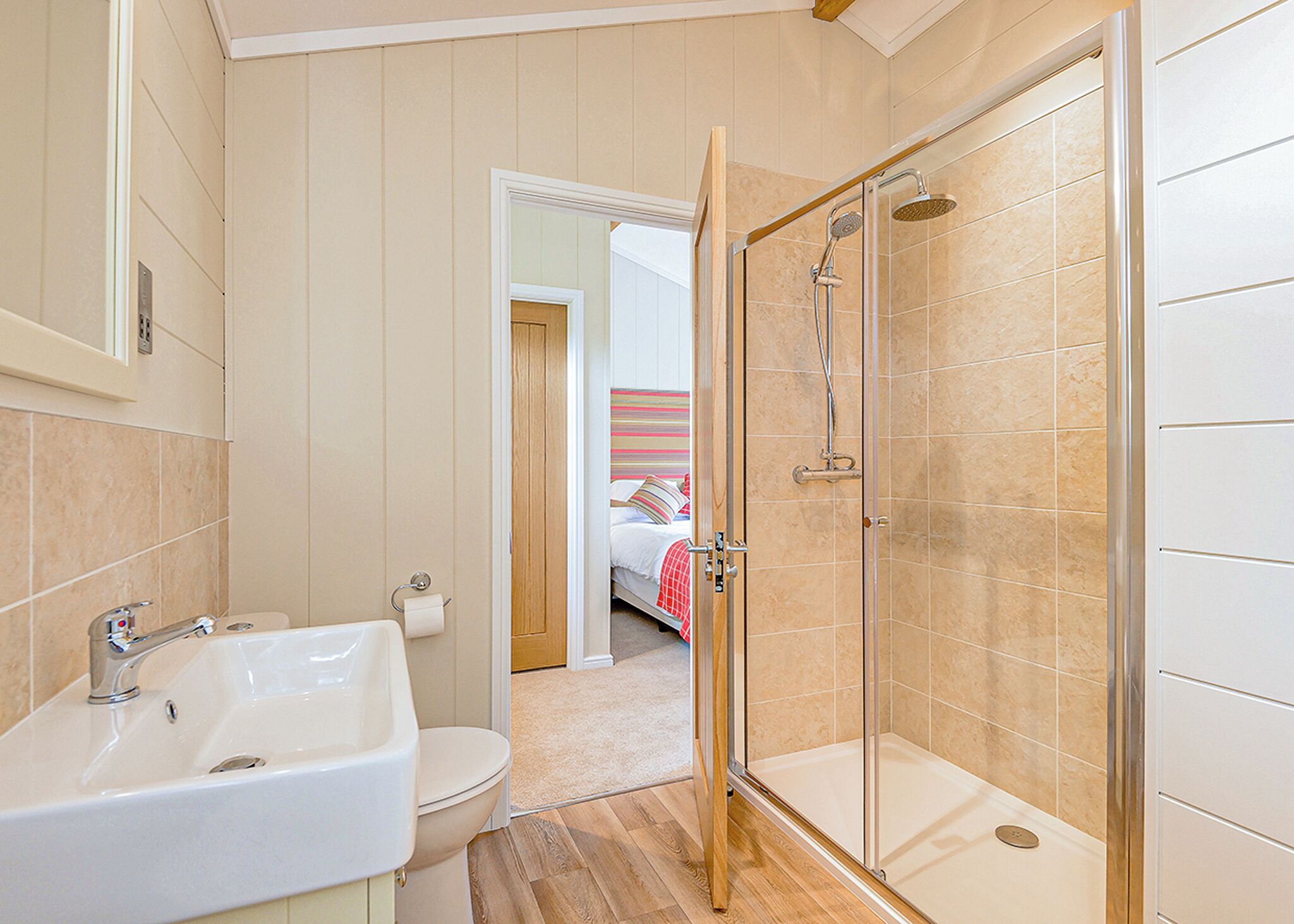 A bathroom with a sink, toilet, and shower.