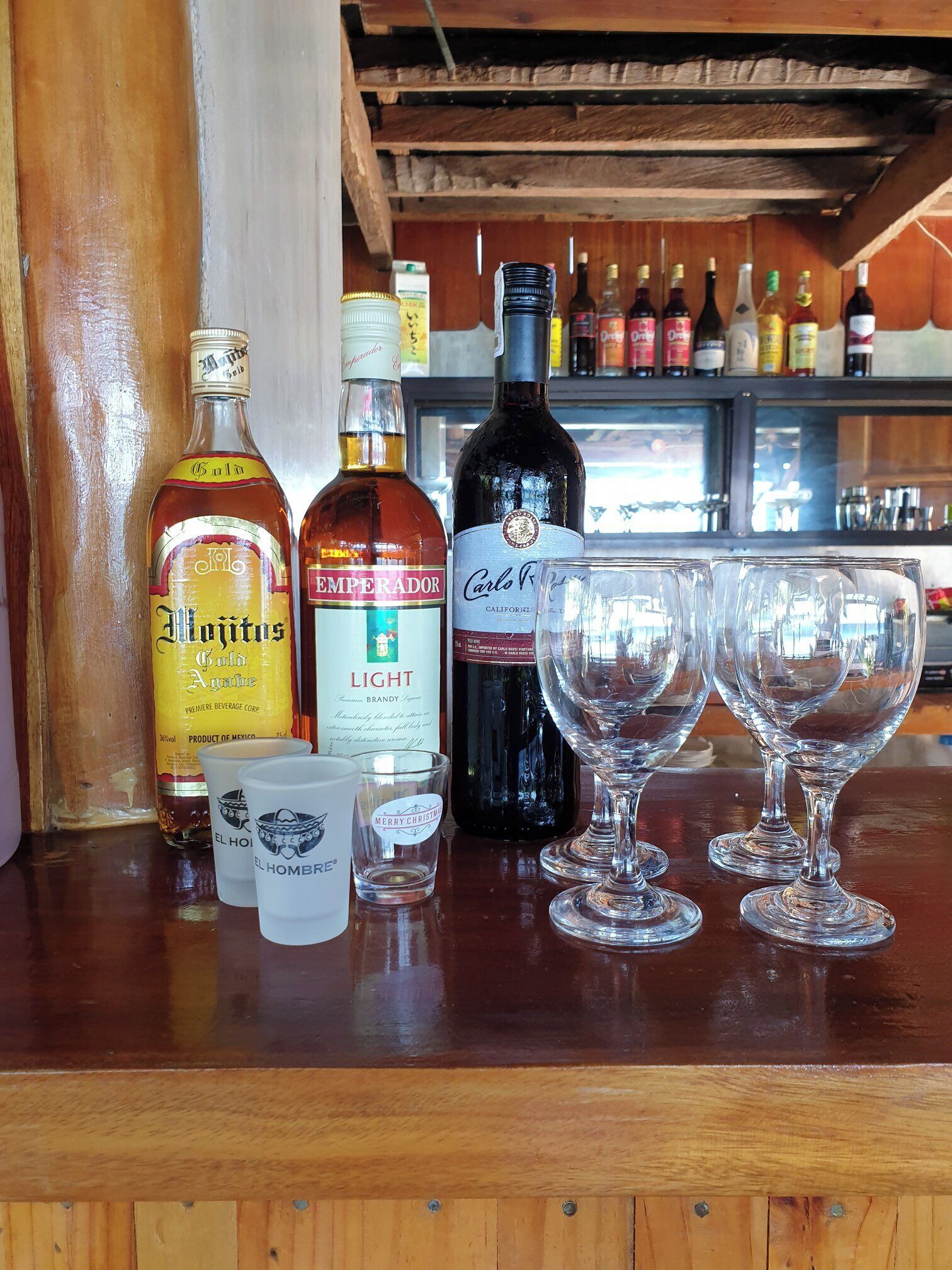 A bar area with various bottles and glasses.