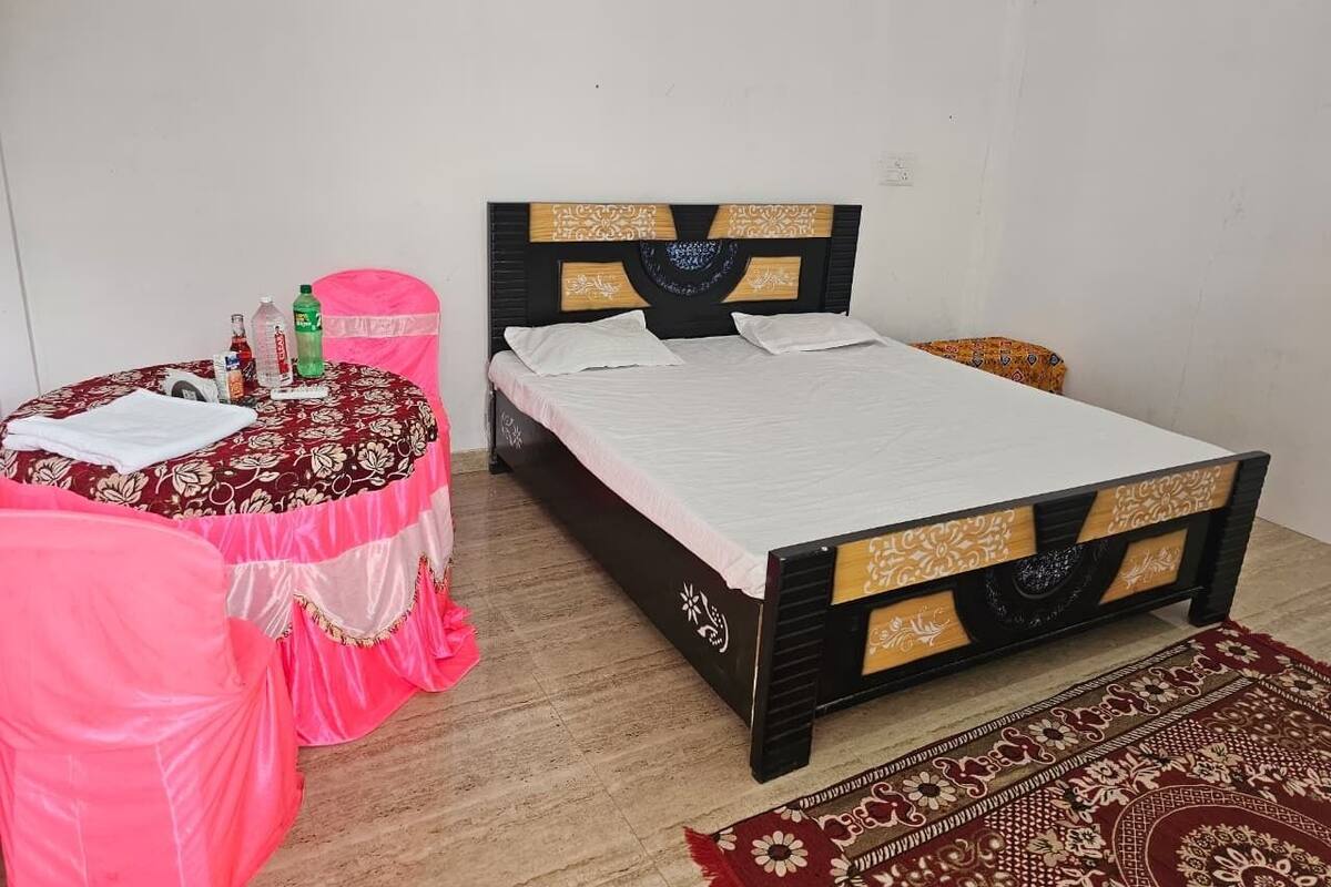 Quarto com uma cama, uma mesa e uma cadeira.