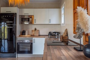 A modern kitchen with a built-in oven, microwave, and a coffee maker. - Beautiful villa with pool and stunning view (Alicantie)