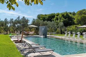 A swimming pool with lounge chairs and a waterfall feature. - Breathtaking Villas Retreat in Salento with 2 swimming pools and Yoga Gym Hamman (Veglie)