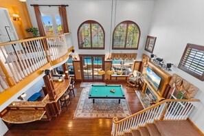 A spacious living area with a pool table, comfortable seating, and a fireplace. - Carmel Valley Villa by Coastline Vacation Rentals (San Diego)