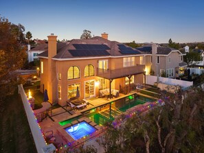 A large house with a swimming pool, solar panels, and a covered patio. - Carmel Valley Villa by Coastline Vacation Rentals (San Diego)